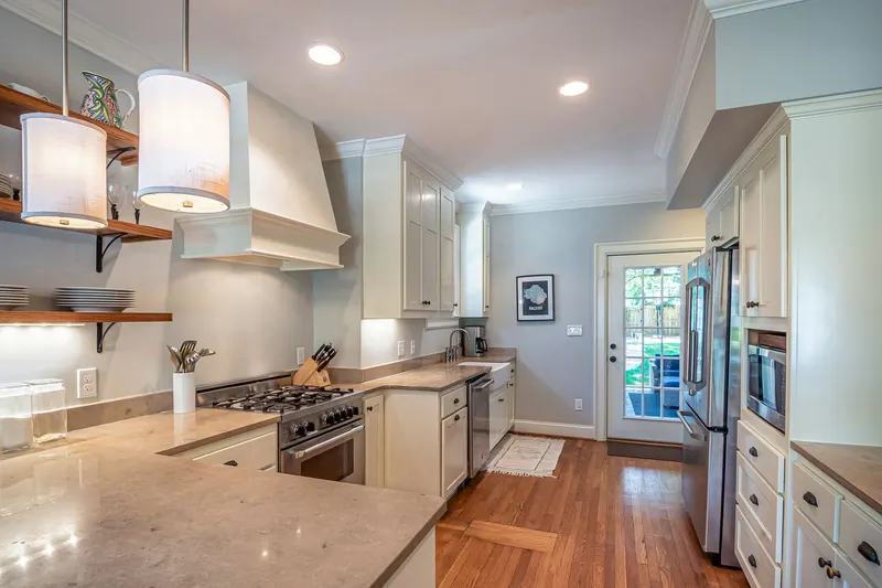 A modern kitchen with parallel countertops and cabinets along two walls.