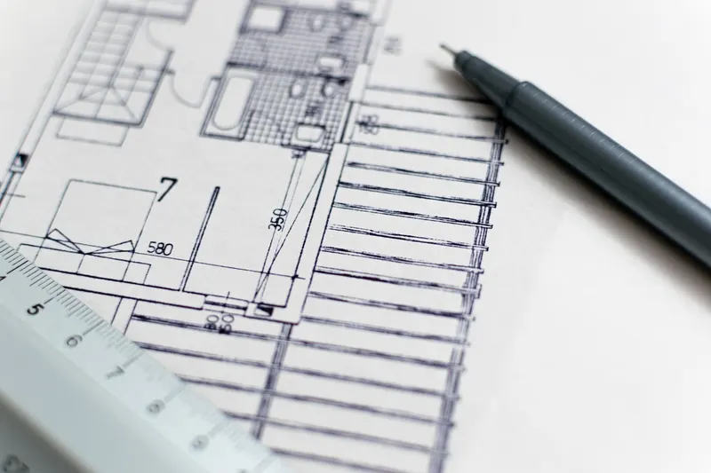 Architectural blueprint with a ruler and pen